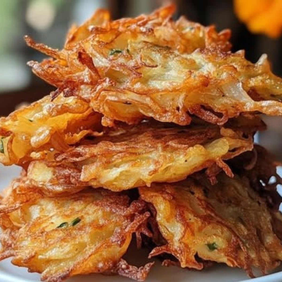 Crispy Amish Onion Fritters stacked on plate